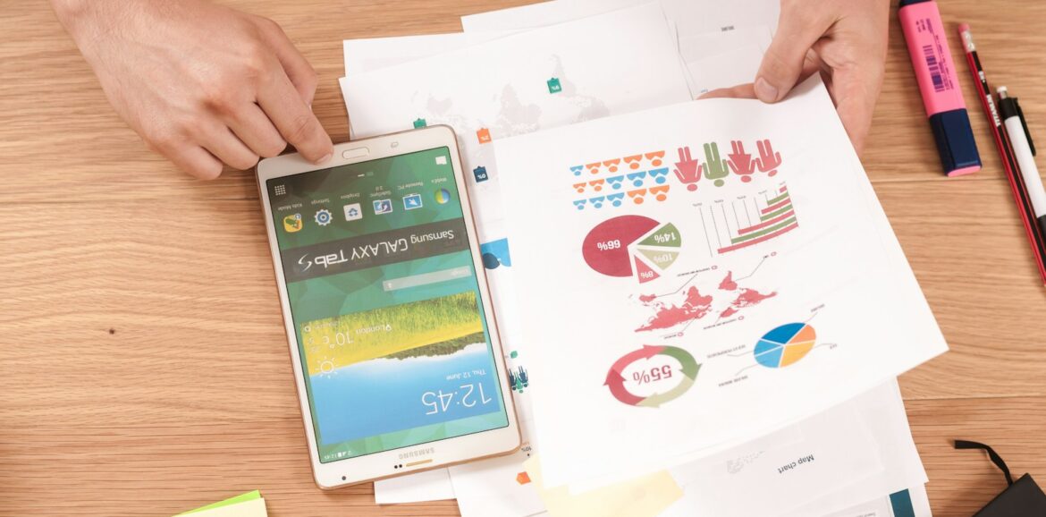 person holding white Samsung Galaxy Tab