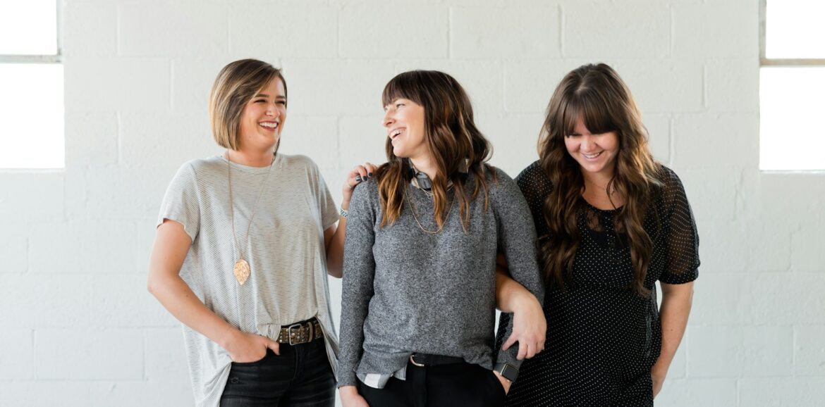 woman in gray crew neck t-shirt standing beside woman in black and gray long sleeve